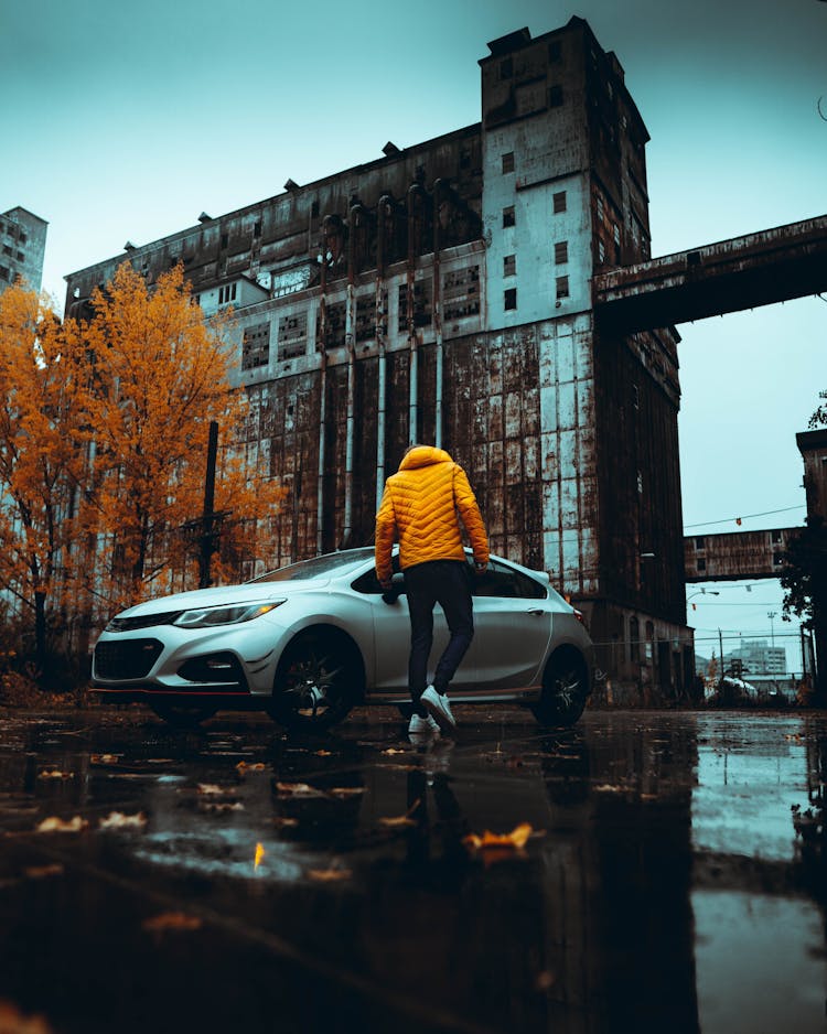 Walking Person, Car And Old Building