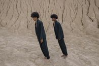 Tilted Men in Full Black Clothing