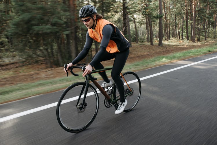 A Cyclist Riding A Bike On The Road