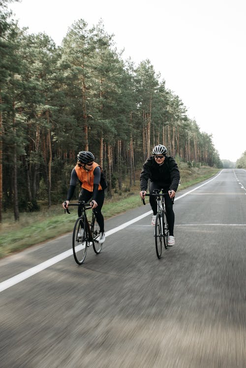 Free Two People Biking on the Road Stock Photo