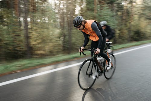 Free A Cyclist Riding a Bike on the Road Stock Photo