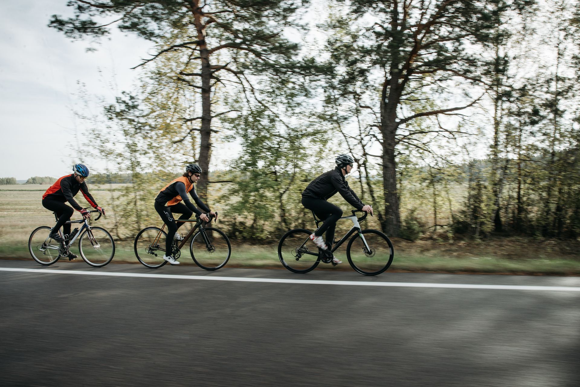 Cyclists enjoying a ride on a scenic road during the day, showcasing outdoor recreation and fitness.