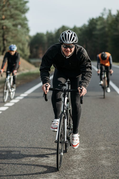 Man in Black Jacket Riding on Bicycle