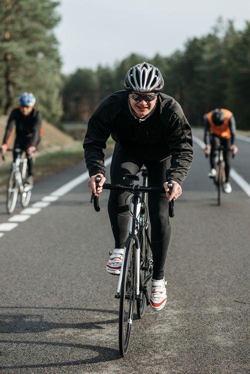 Free Group of cyclists racing on an open country road. Stock Photo
