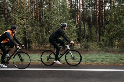 Free Man in Black Jacket Riding on Bicycle on Road Stock Photo