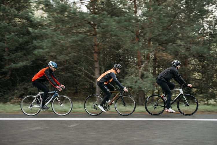 Men Riding Bicycles On The Road