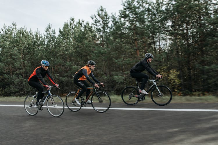 Men Riding Bicycles On The Road