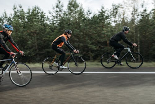 Men Riding on Bicycle on Road