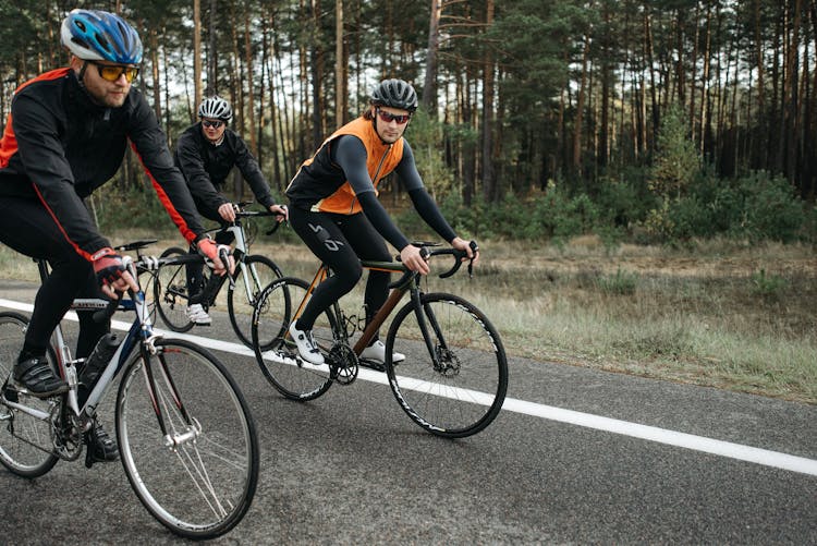 Men Riding Bicycles On The Road