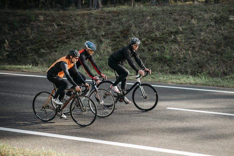 Men Riding Bicycles On The Road