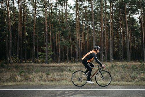 Man riding Black Bicycle on Roadside 