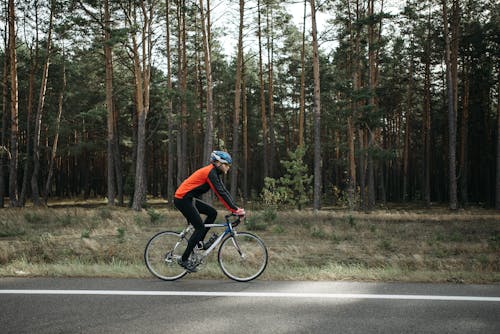 Free Man riding Black Bicycle on Roadside  Stock Photo