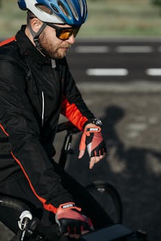 Man in cycling gear preparing for a ride on a sunny day.