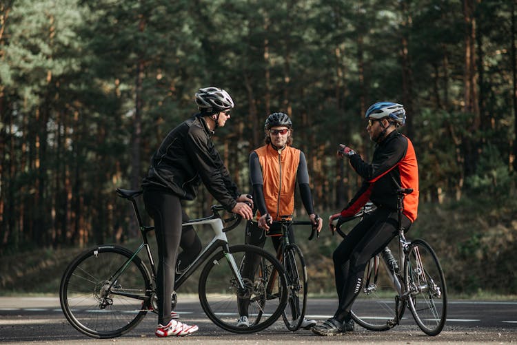 Men Riding Bicycle On Road