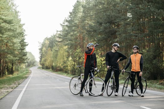 Three cyclists pause for a break in a serene forest setting, enjoying the outdoors.