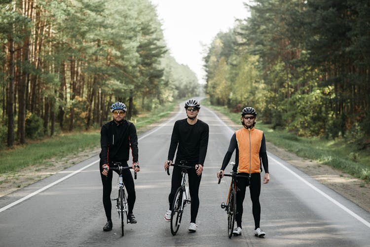 Men Riding Bicycle On The Road