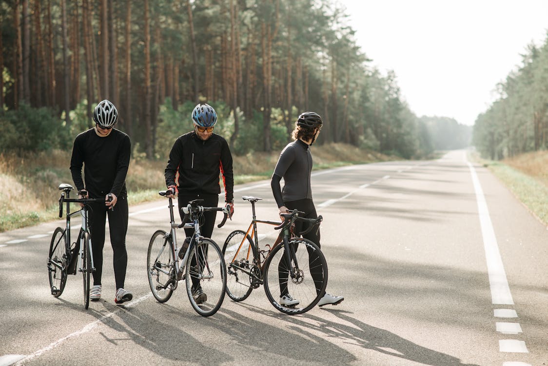 Men Riding on Bicycle on Road