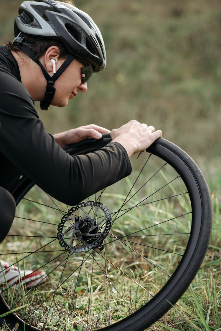 A Man Fixing A Bicycle Tire