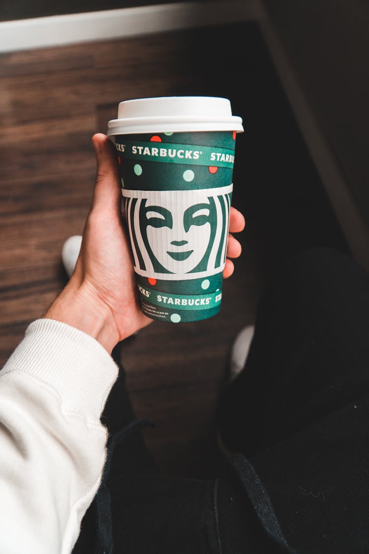 Person With Cup Of Takeaway Coffee In Hand