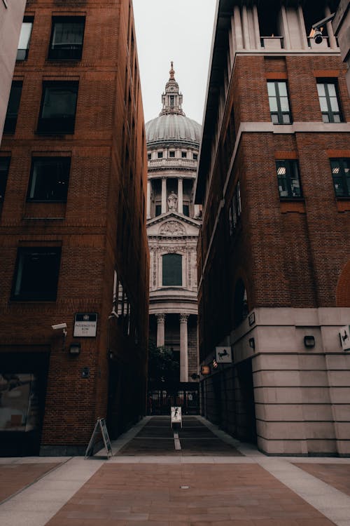Free Photo of St Paul's Cathedral through Brick Buildings Stock Photo