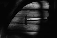 Hammer on weathered lumber planks in village