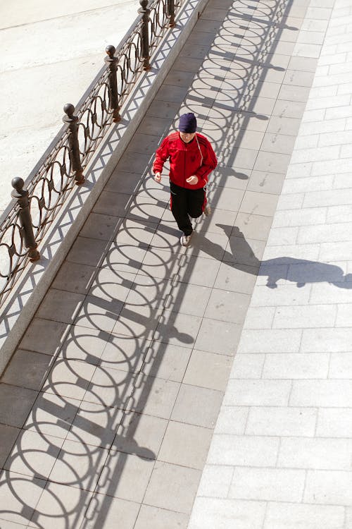 Free Unrecognizable man running on embankment in city Stock Photo
