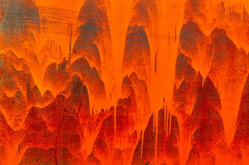 Free Energetic abstract artwork showcasing vivid orange shades and dynamic textures. Stock Photo
