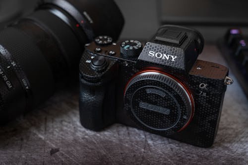 Black Sony Camera on Brown Textile