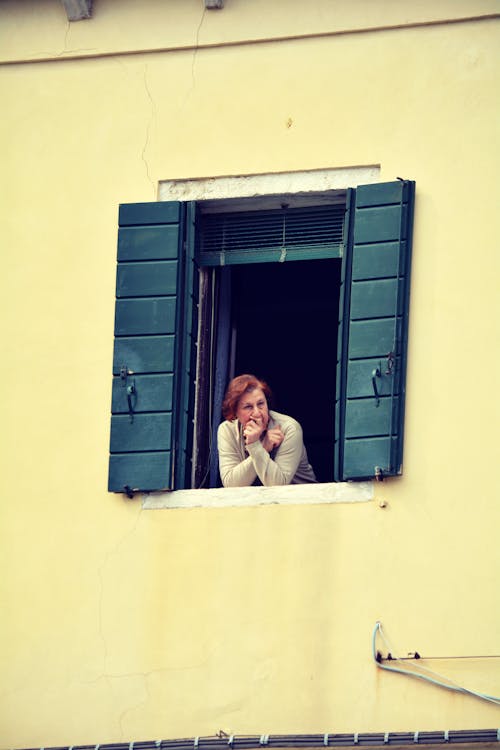 Free A Woman Looking Outside the Window Stock Photo