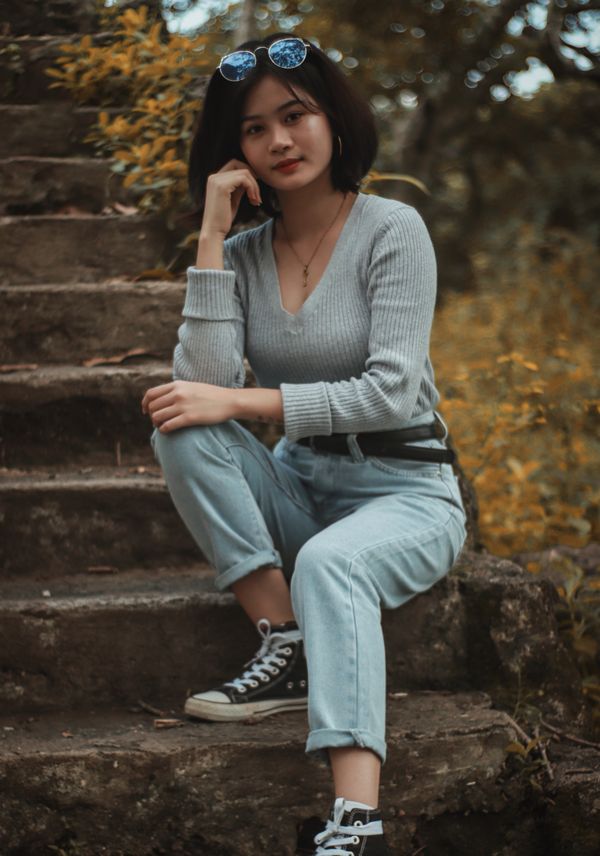 Woman in cuffed jeans with sneakers and striped top