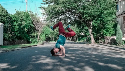 Man Doing Head Stand on Road