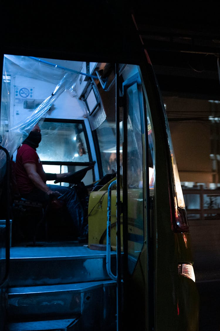 A Buys Driver With Mask Sitting On A Driver Seat 