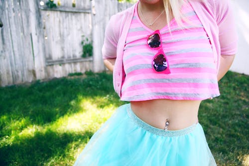 A Woman in Pink Striped Shirt and Blue Skirt