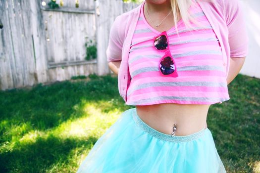 A Woman in Pink Striped Shirt and Blue Skirt