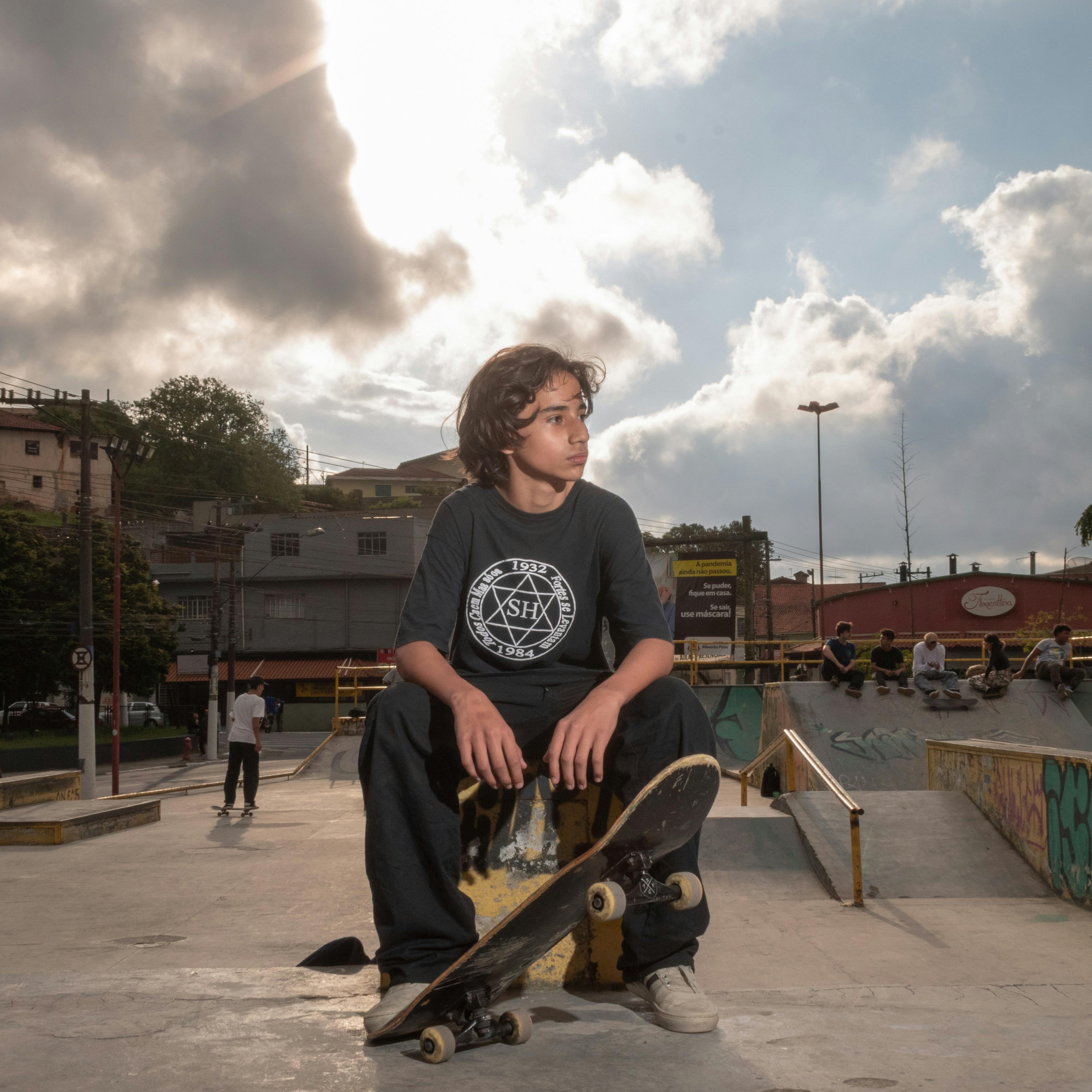 Young Girl in Red Leather Jacket Sitting on a Skateboard on Ramp · Free