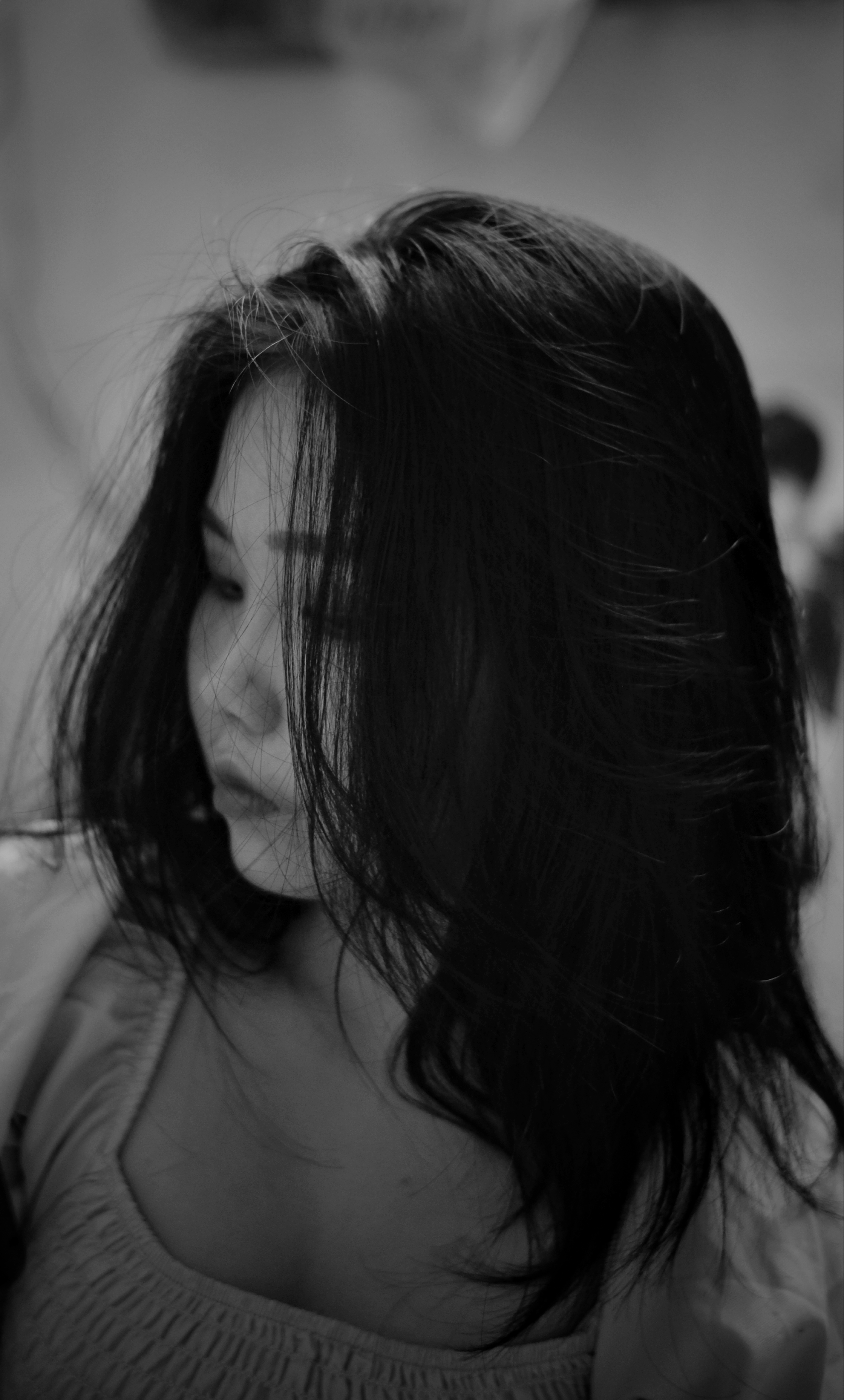 Artistic black and white portrait capturing a thoughtful young woman.