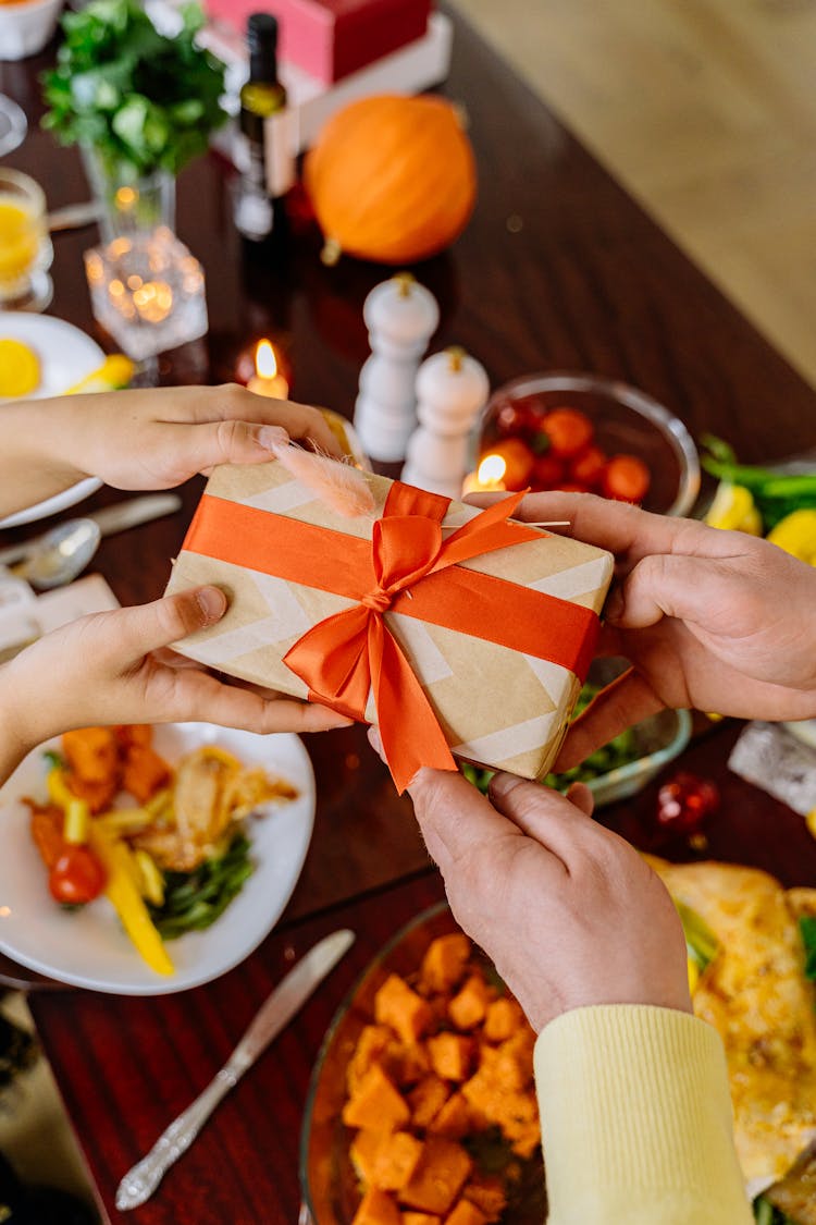 Person Giving A Gift Box