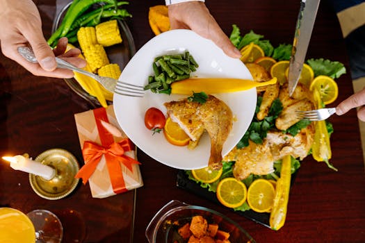 A top view of a roasted chicken dinner with fresh vegetables and citrus garnishes, perfect for festive gatherings.