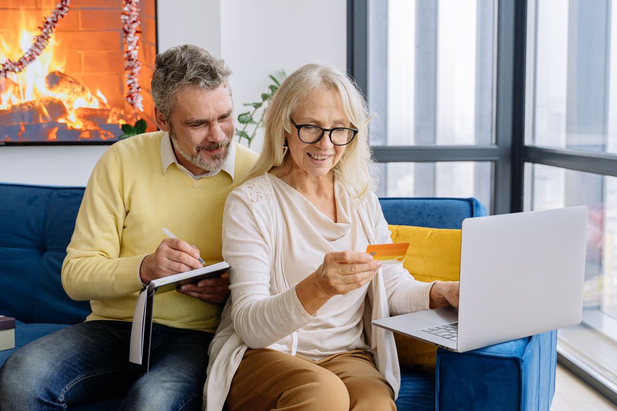 Older couple reviewing a bank card and managing their finances