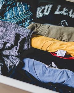 A neat arrangement of clothes and T-shirts in a drawer, showcasing casual wear.