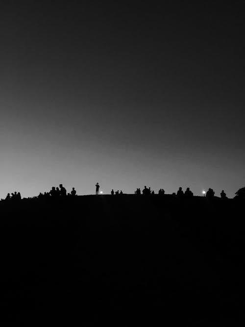 Silhouette of People Standing on Hill