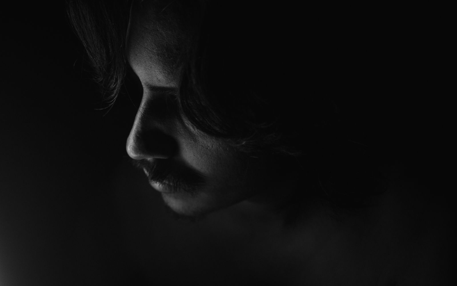 Black and white profile in low light — photo by Mauricio Mascaro on Pexels
