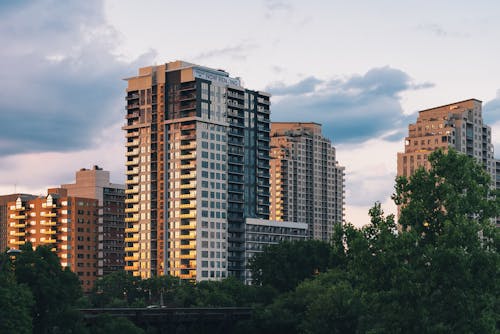 Modern Apartment Buildings Among Trees at Sunset