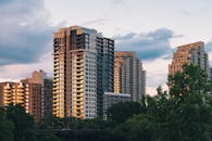 Modern Apartment Buildings Among Trees at Sunset