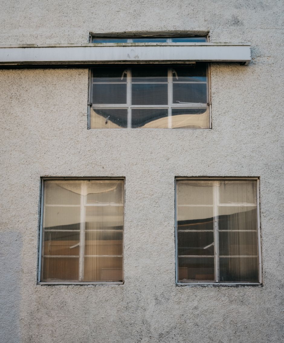 Close view of a concrete building facade and its window openings