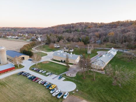 Aerial view of a countryside estate with parked cars and outbuildings in Rochester, MN.