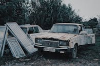Shabby broken cars in abandoned field