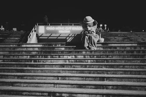 Anonymous person in bear costume sitting outside