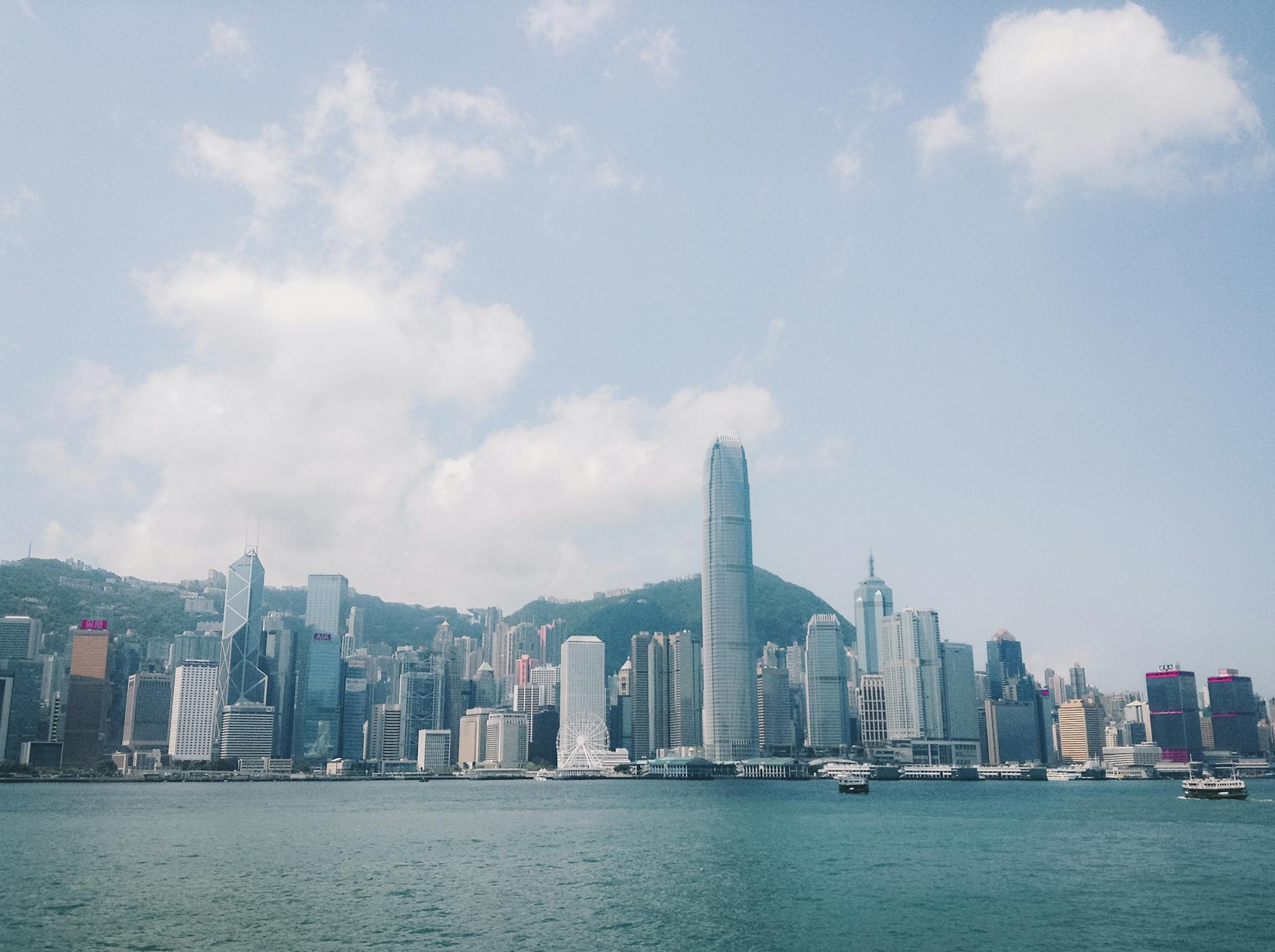 Stunning cityscape of Hong Kong skyline featuring Victoria Harbour and high-rise buildings.