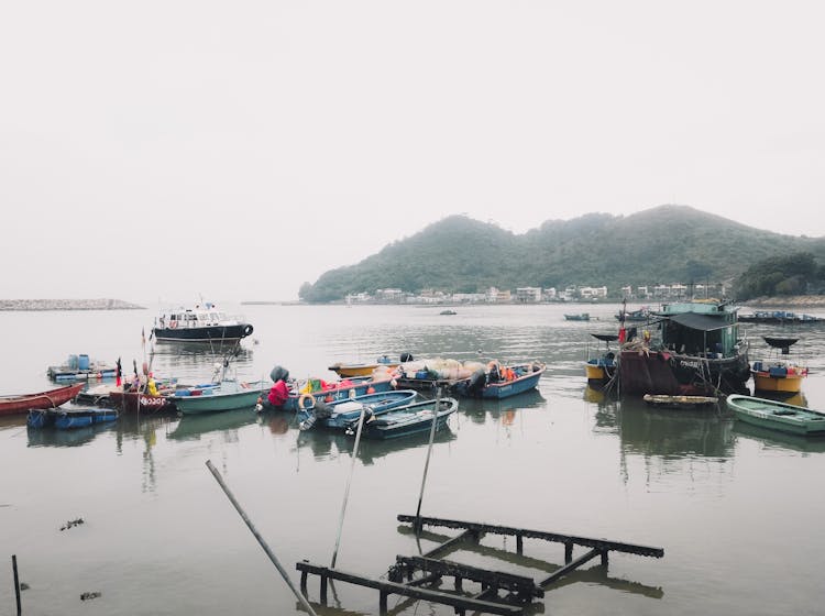 Fishing Boats On River Water In Coastal Town